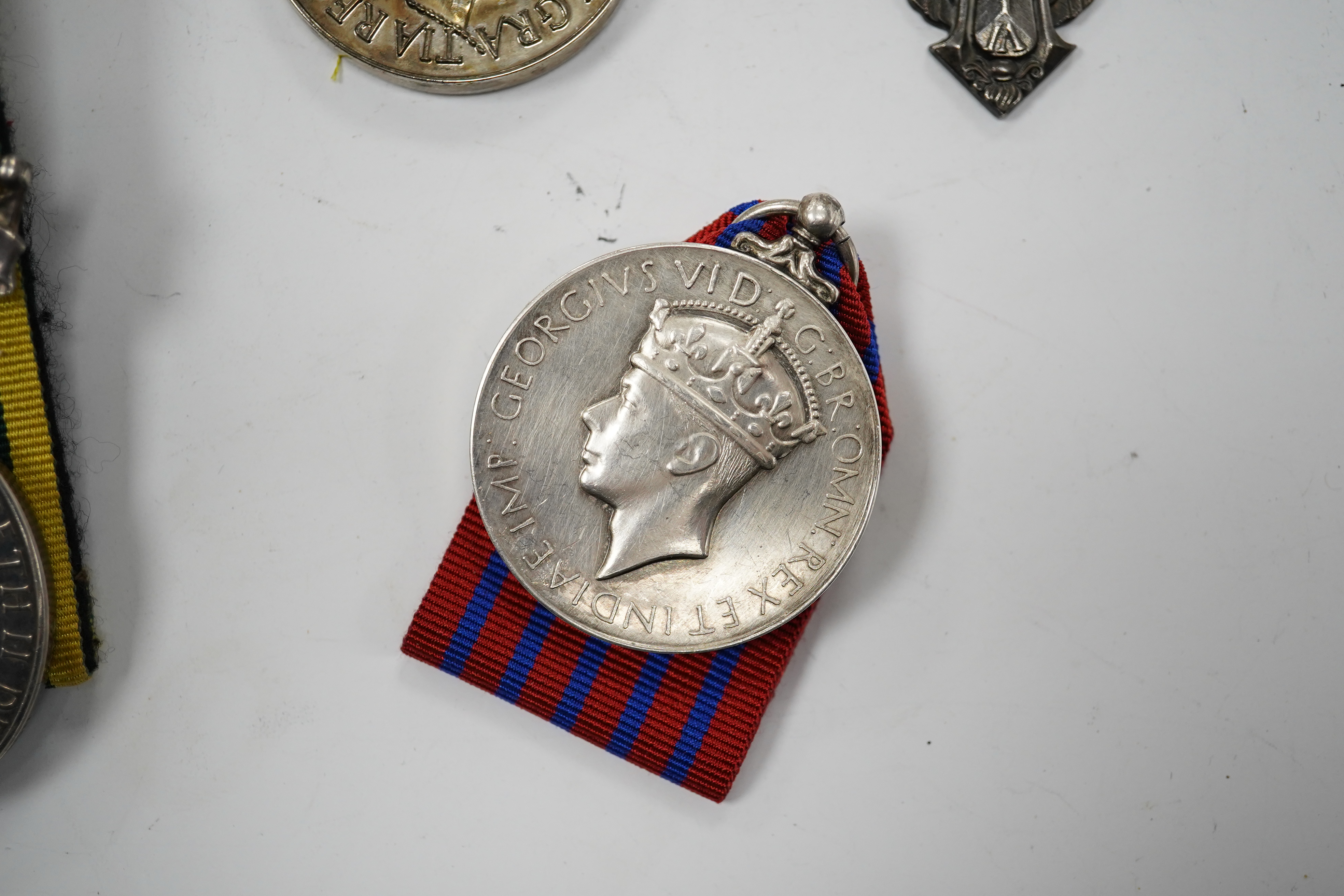 Twelve ERII and George VI medals, some medals arranged into two medals groups (containing unnamed medals and medals awarded to different recipients within the same group), including